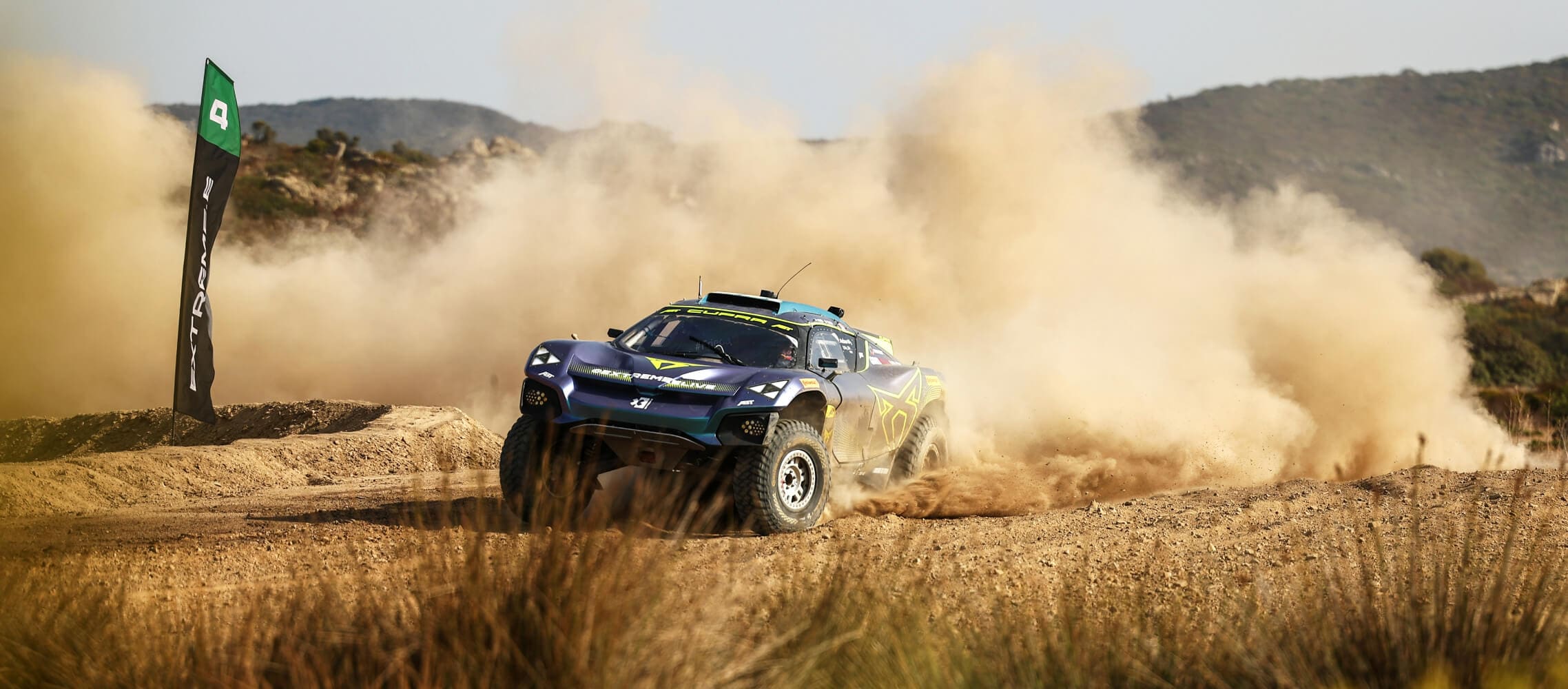 The CUPRA XE Tavascan speeding along a desert track