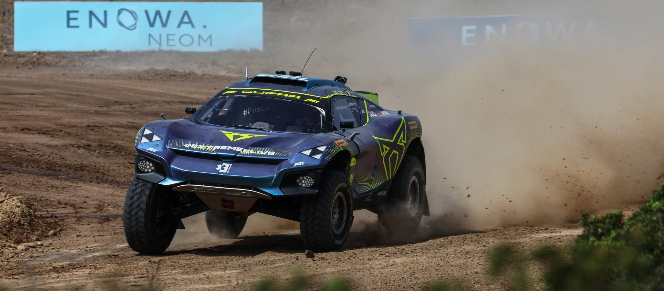 The CUPRA Tavascan XE speeding along a dirt track