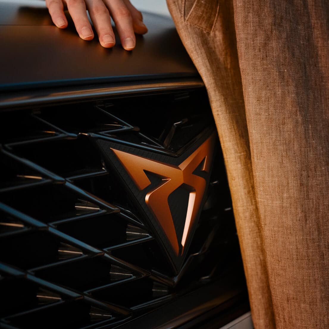 A woman next to the CUPRA logo