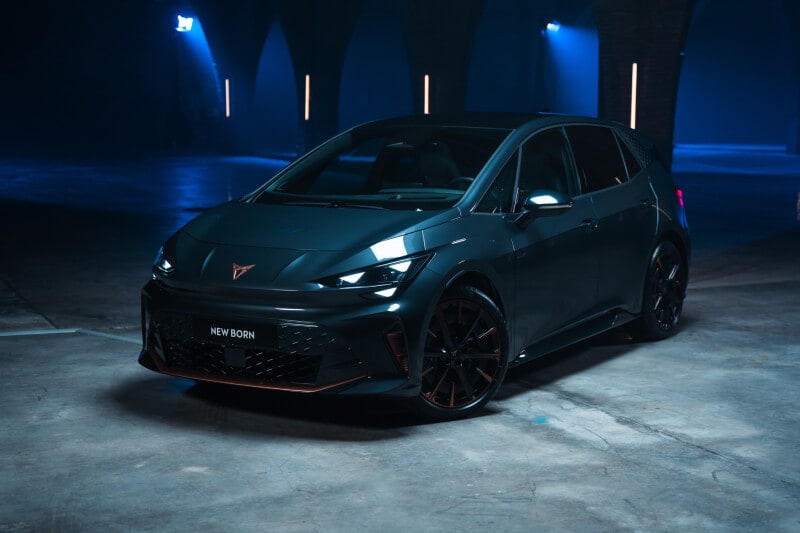 Front view of the new CUPRA Born on a dark industrial background
