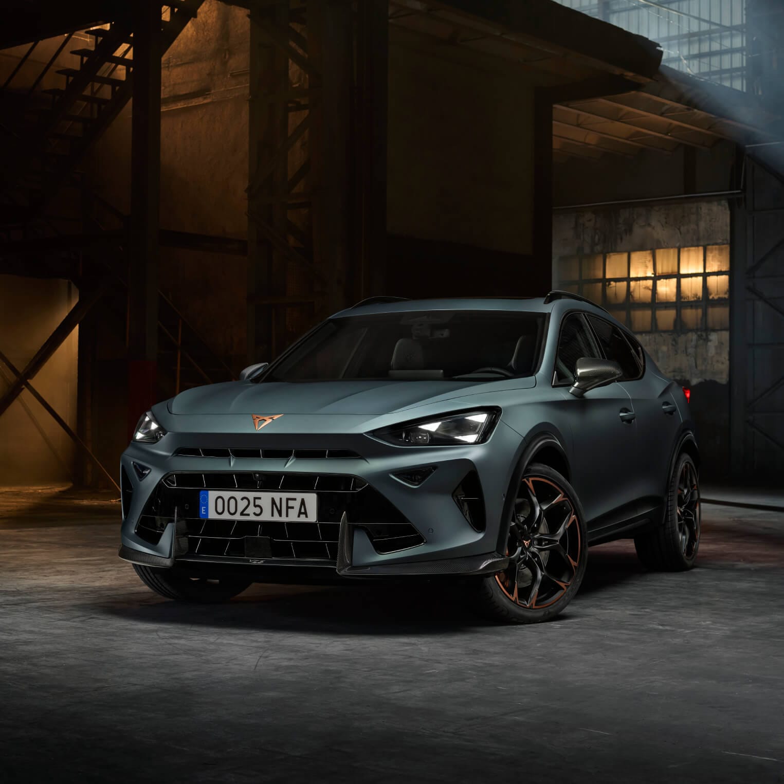 Front view of the CUPRA Formentor VZ5 with a dark industrial background