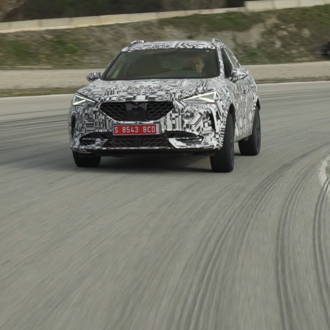 A disguised CUPRA Formentor on a racetrack