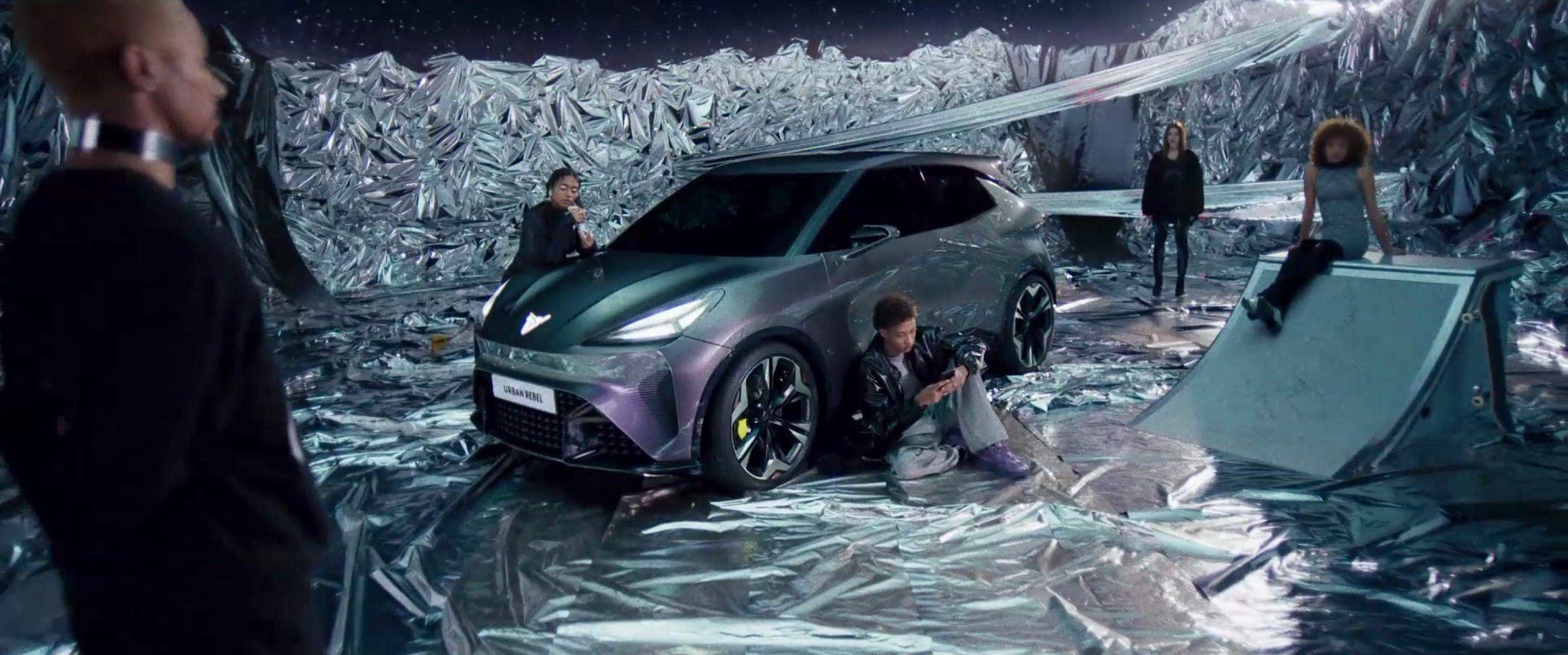 Actors surrounding a CUPRA Urban Rebel on a movie set
