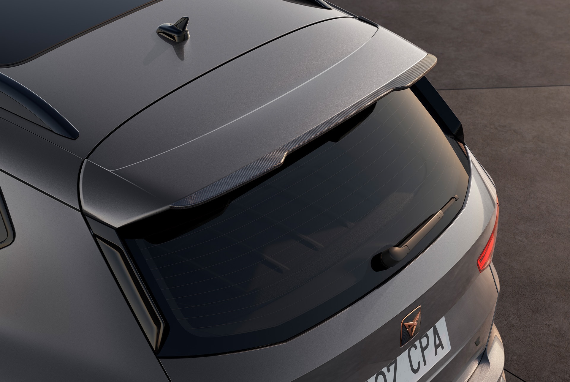 Rear view of the CUPRA Ateca with a person standing beside it, highlighting flexible monthly payment options for servicing and car maintenance.