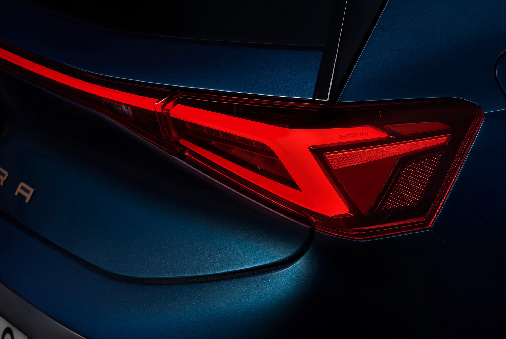 Details of the CUPRA Born's rear light. The car is in the colour aurora blue.