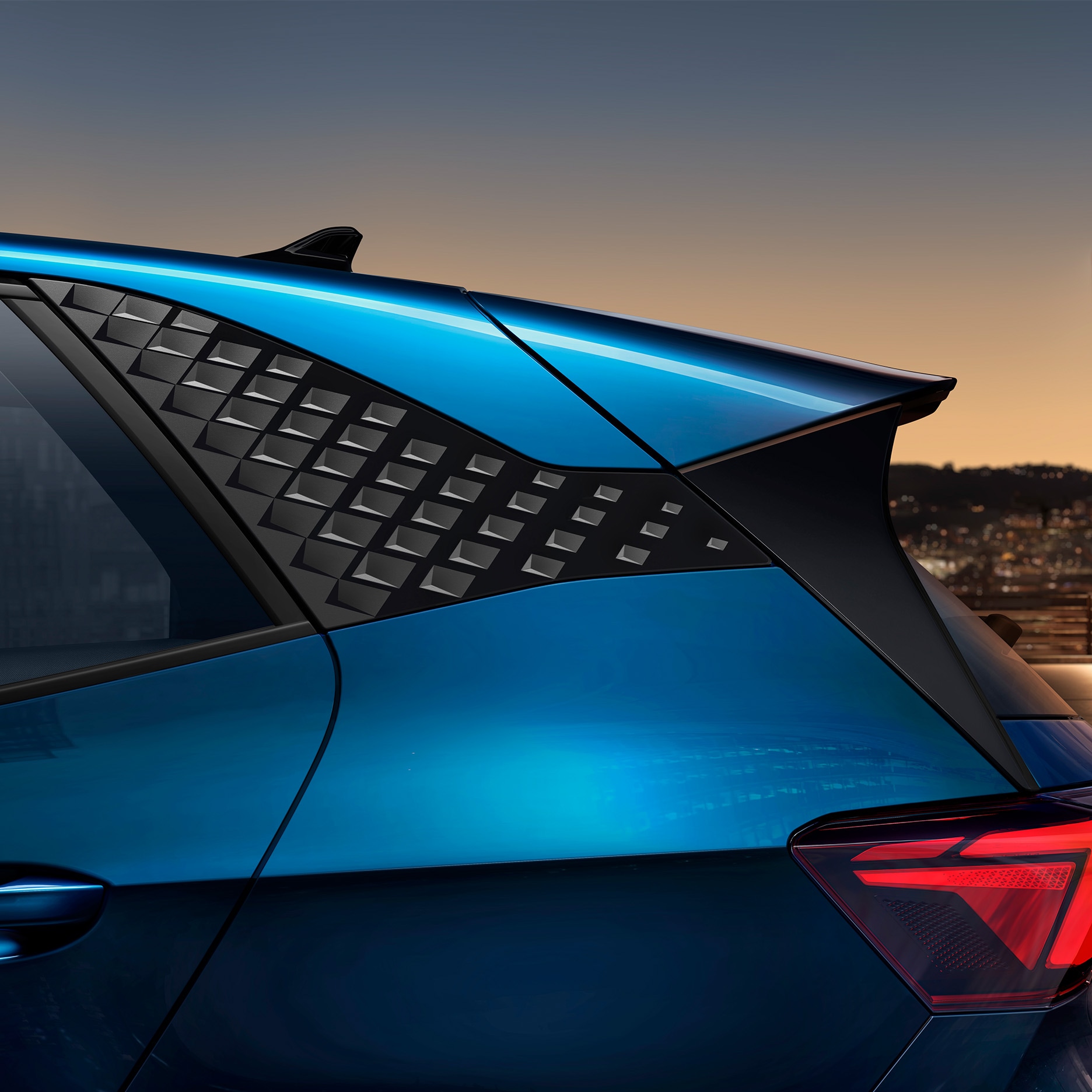 Close-up of the textured CUPRA Born's c-pillar in aurora blue, at sunset.