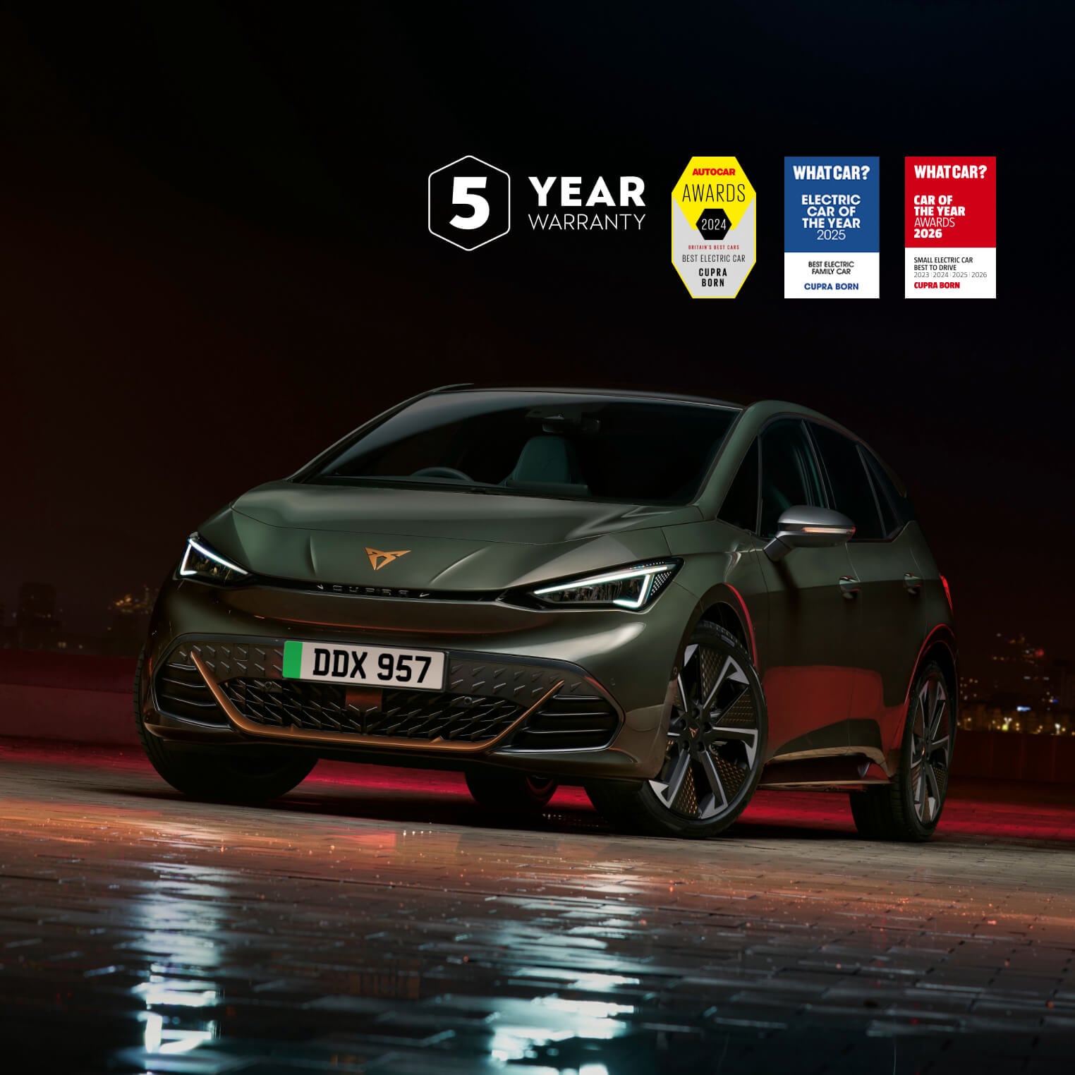 A CUPRA Born parked with a city skyline at night in the background with 3 logos in the right corner: 5 Year Warranty logo, AutoCar Awards 2024 and WhatCar? Car of the year Awards 2026: Small Electric Car Best to drive: 2023, 2024, 2025 and 2026
