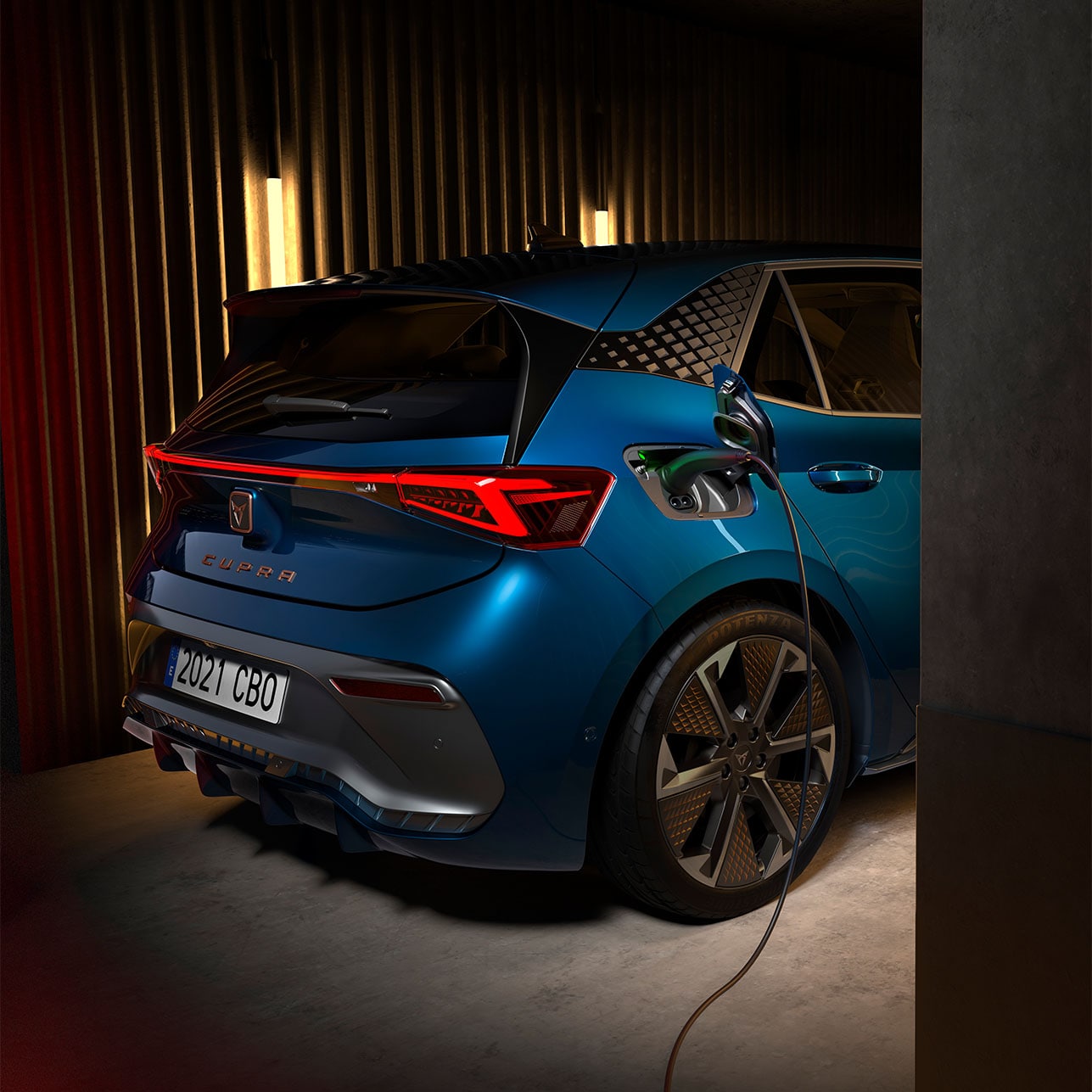Woman posing while a CUPRA Born Aurora Blue colour charging