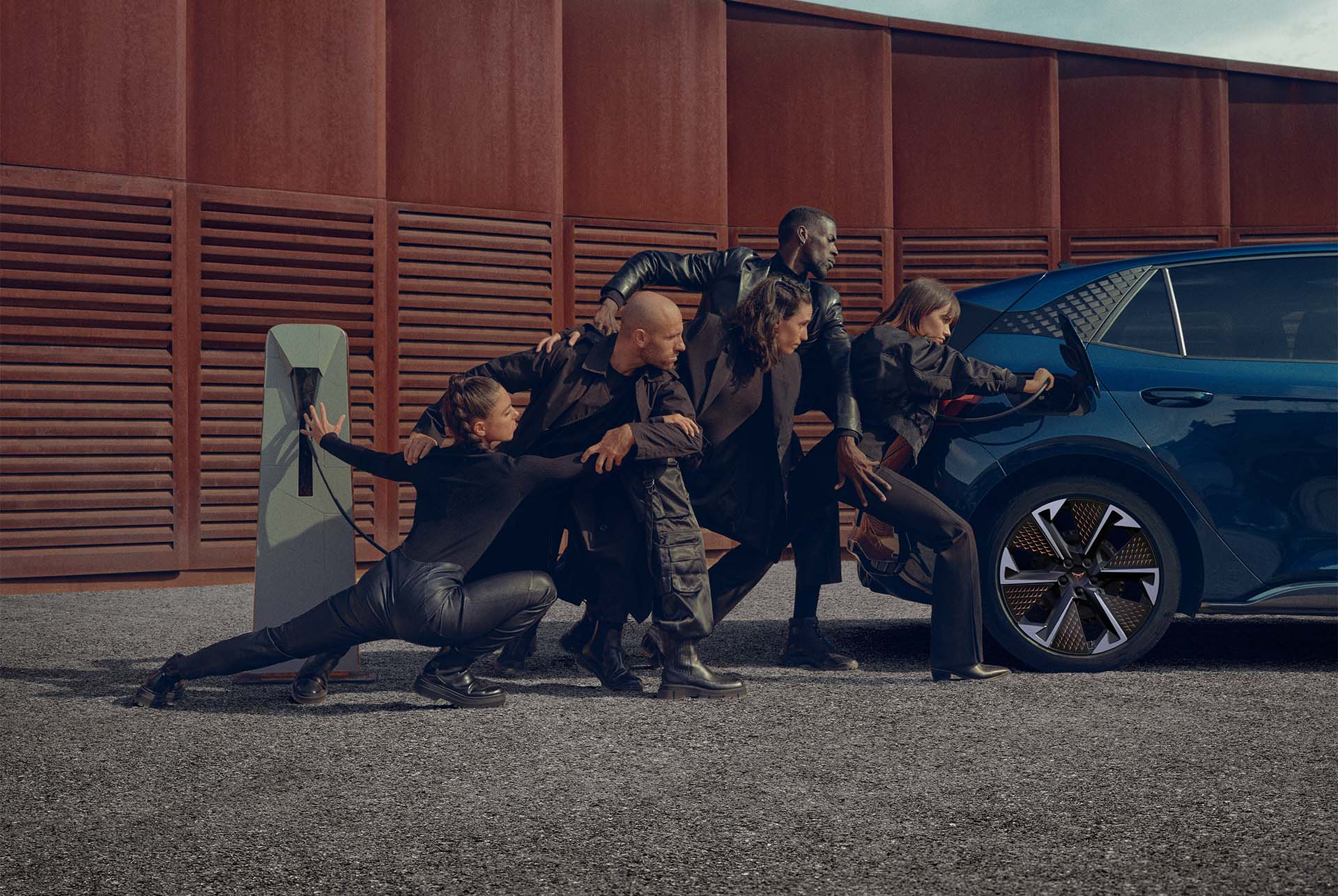Women posing with CUPRA Born charging at home