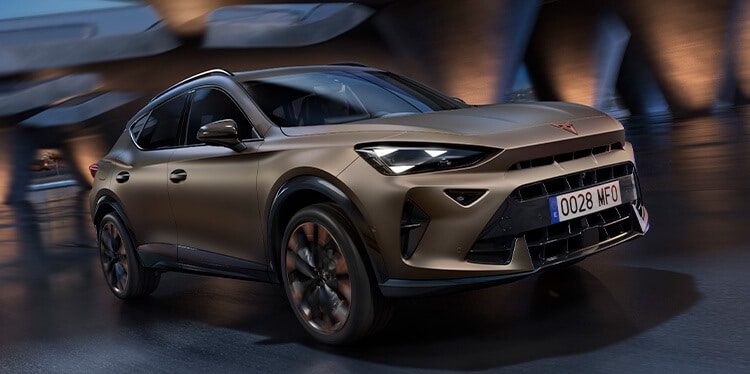 a bronze CUPRA Formentor driving under a low lit bridge