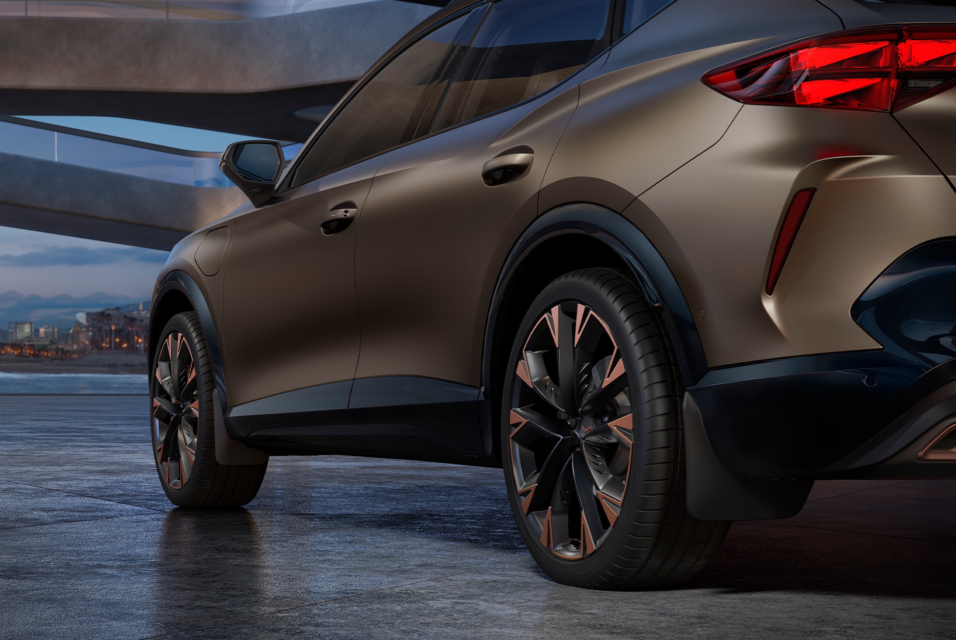 century bronze CUPRA Formentor 2025 rear and towing bike rack car accessory, city skyline in the background.