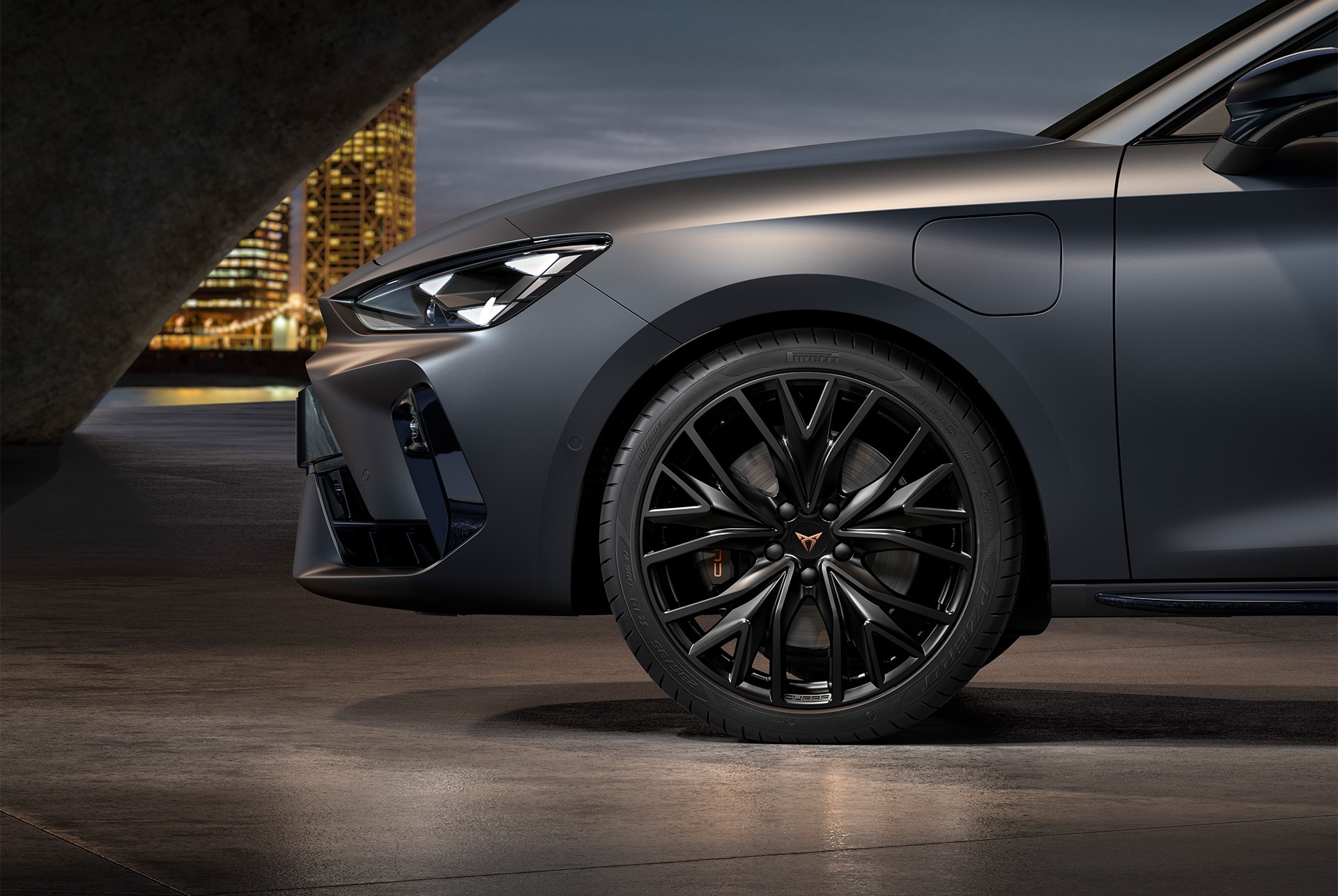 front side view of left forged alloy wheel in black for the new cupra leon 2025, tyres, signature headlights and matt grey body