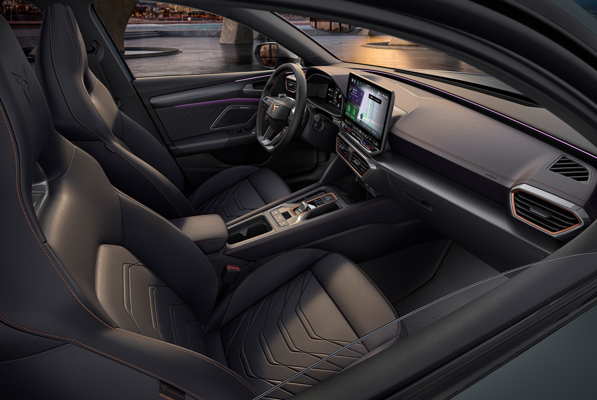 Interior of grey CUPRA Leon Estate, front passenger and driver seats, infotainment system, cupra wheel, bucket seats, at sunset.