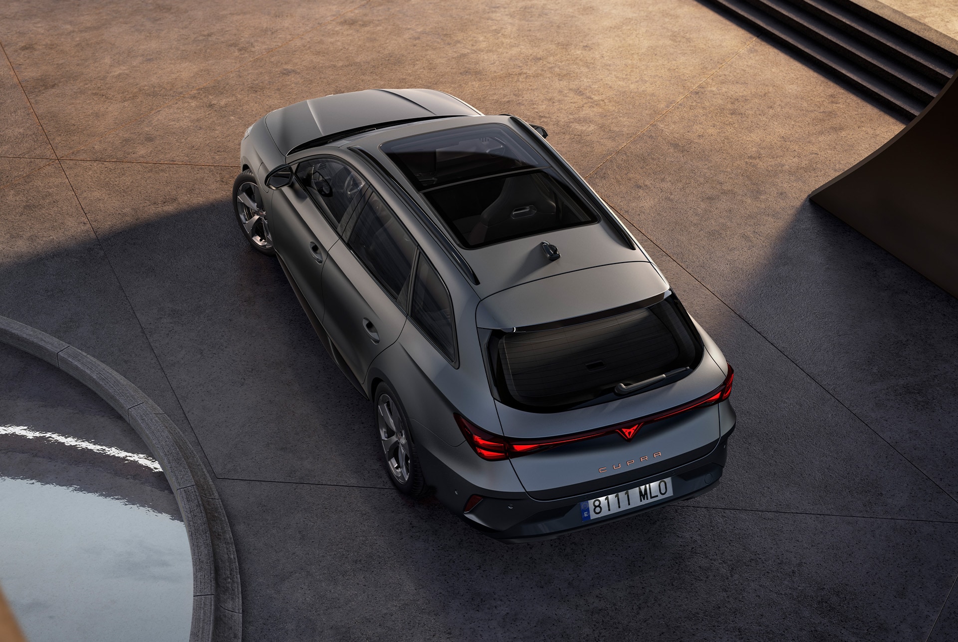 This image features a bird’s-eye rear view of the CUPRA Leon Estate in sleek matte grey. Its sporty and refined design is accentuated by the natural light, showcasing its modern and dynamic styling.