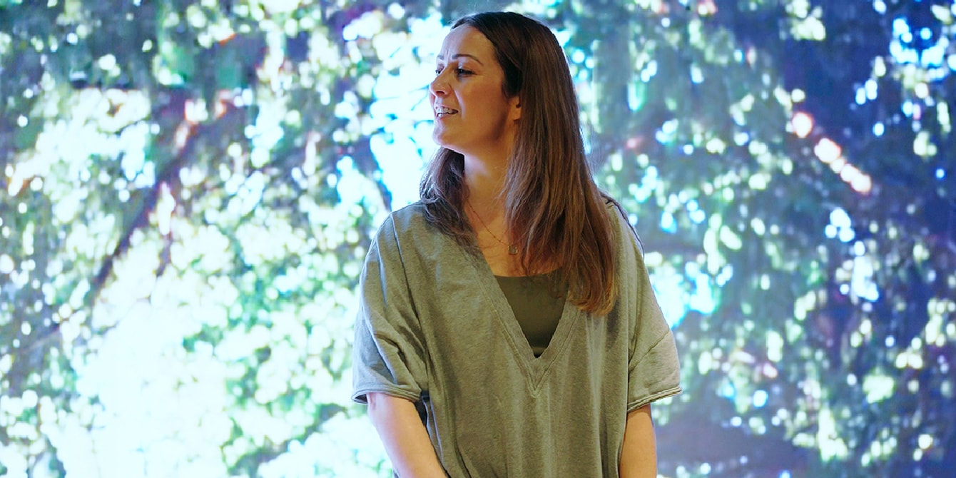 A woman in a yoga pose looking to one side