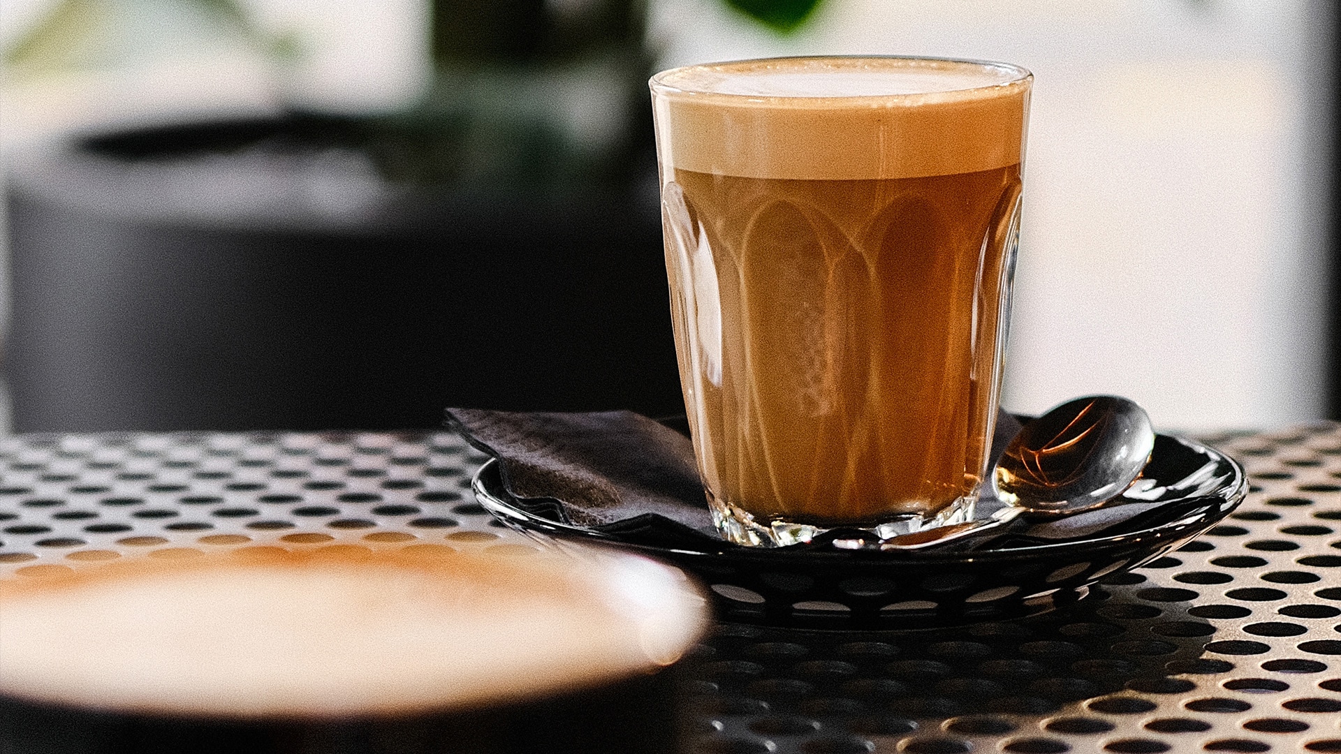 A cup of hot chocolate with whipped cream and syrup