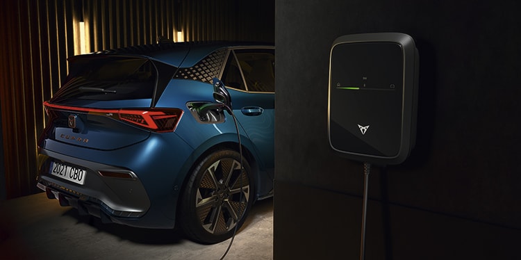 the electric cupra born car plugged into ev wall charger with remote charging benefits such as start, stop and schedule function the electric cupra born car plugged into ev wall charger with remote charging benefits such as start, stop and schedule function