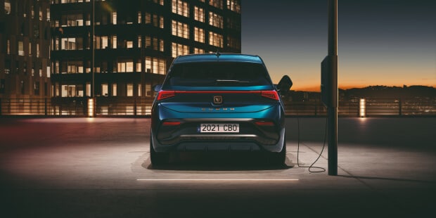 Rear shot of a CUPRA Born charging from a lamppost