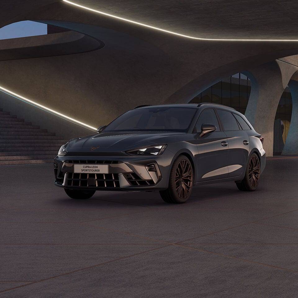 A CUPRA Leon Estate parked beneath a bridge