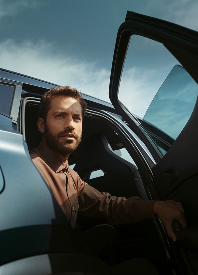 Man sitting in CUPRA car with door open