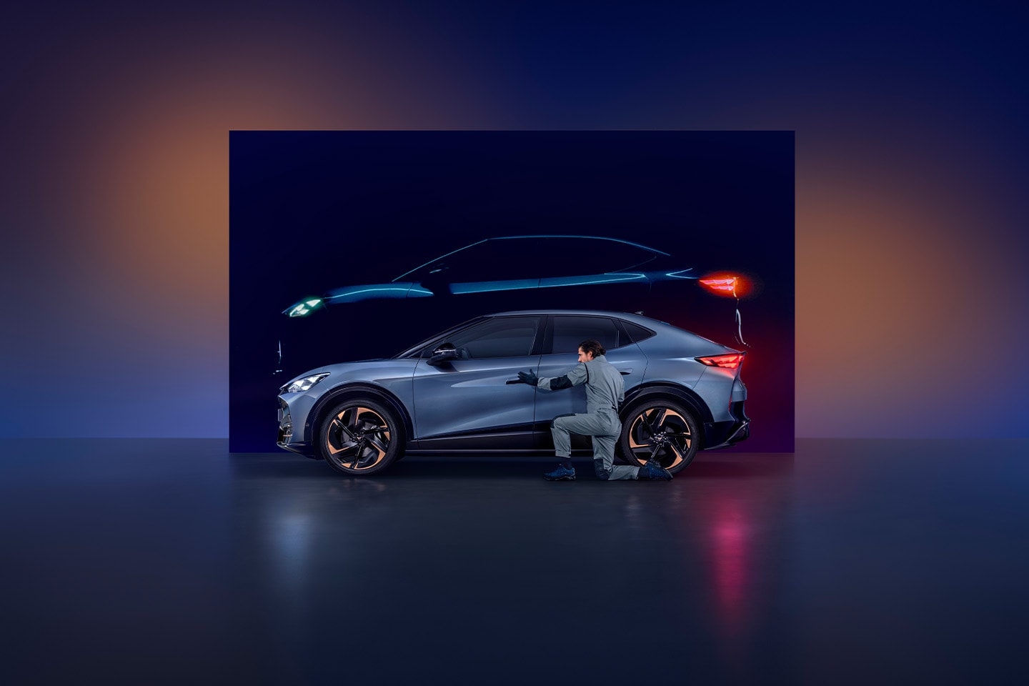 Side view of a CUPRA car with a man in work overalls inspecting the bodywork of the car