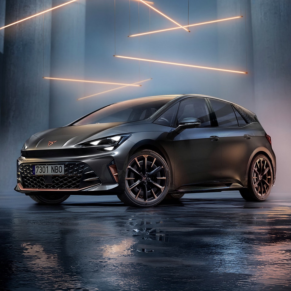 A CUPRA Born in a dark room with strobe lights surrounding it