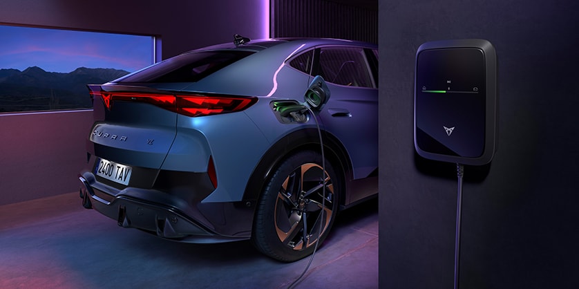 A CUPRA Tavascan being charged from a wallbox device