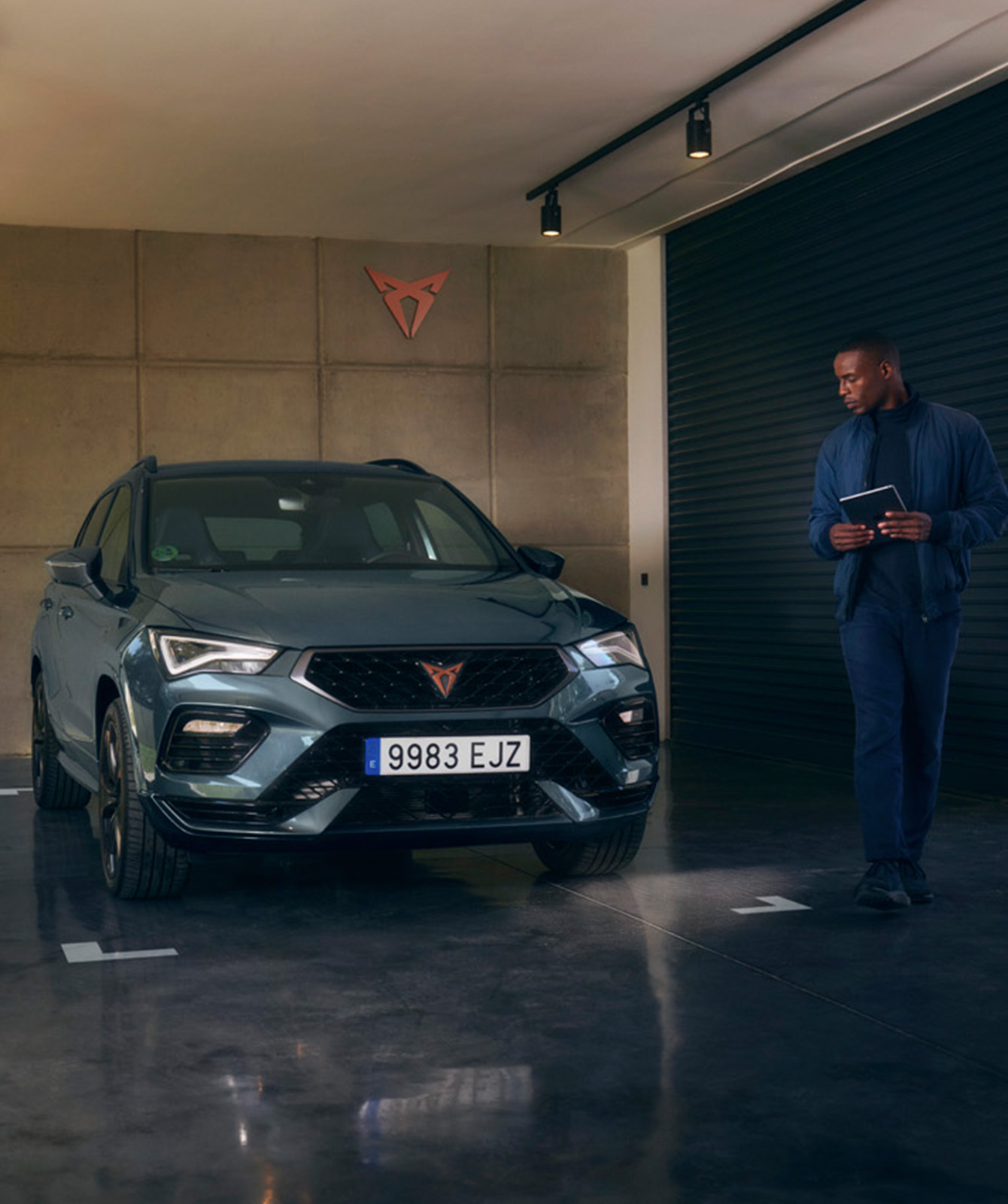 A man in showroom next to a CUPRA Formentor