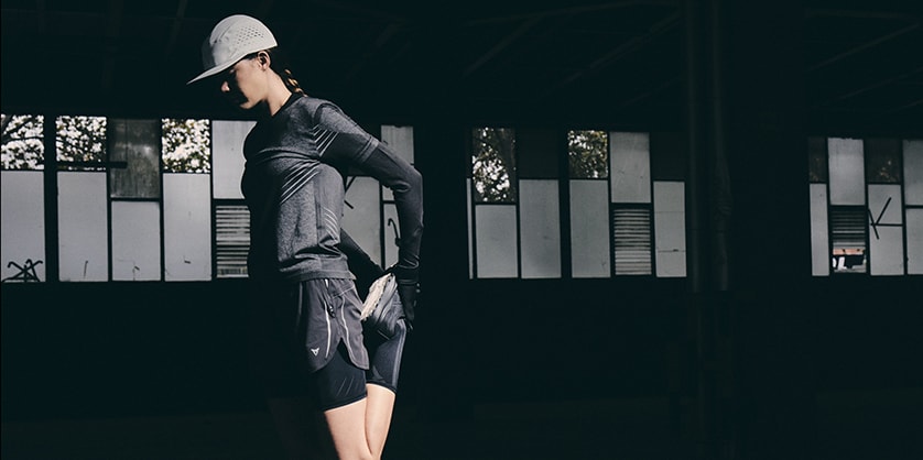 A woman in running wear stretching her leg
