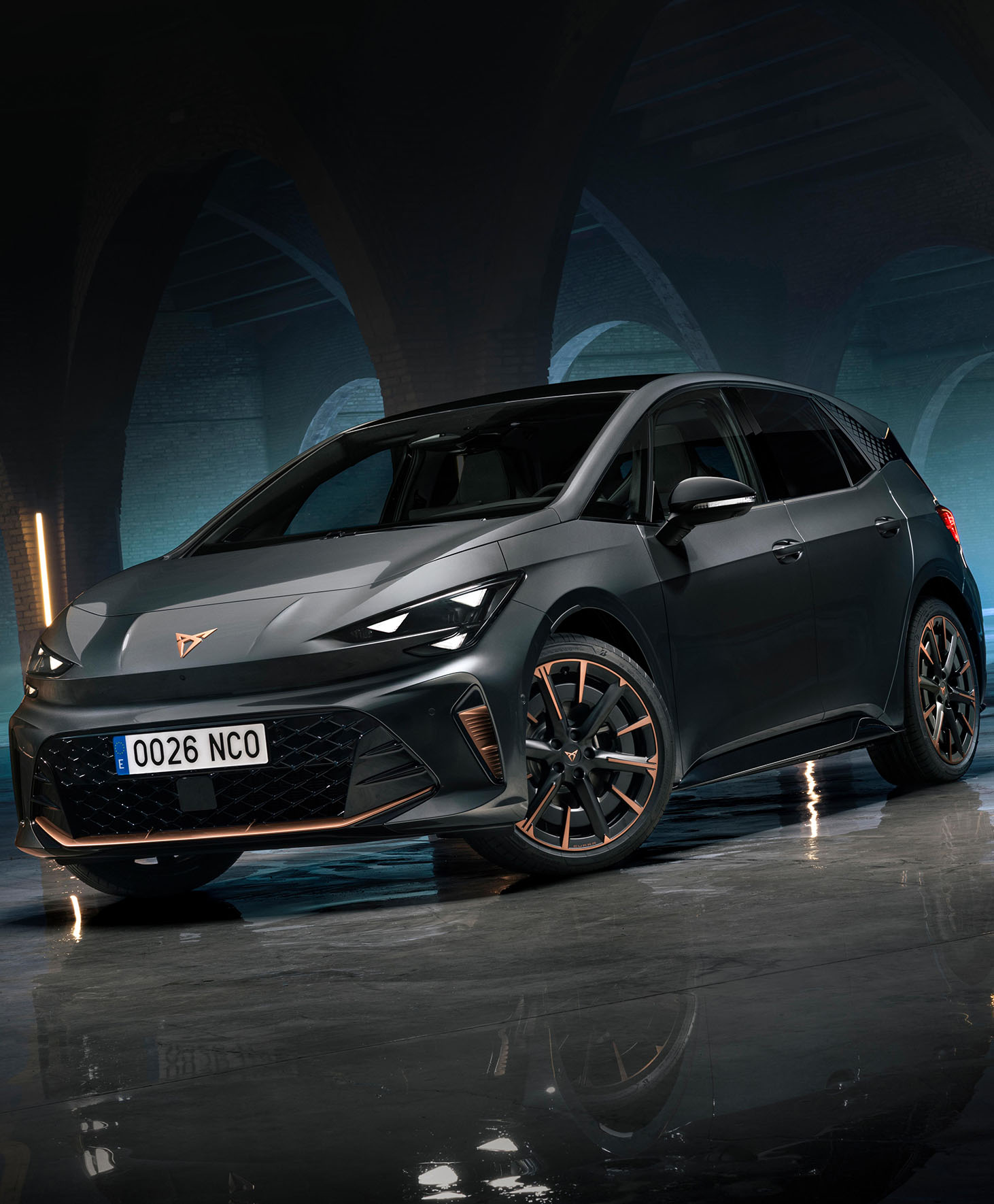 a dark grey new CUPRA Born in an industrial warehouse setting