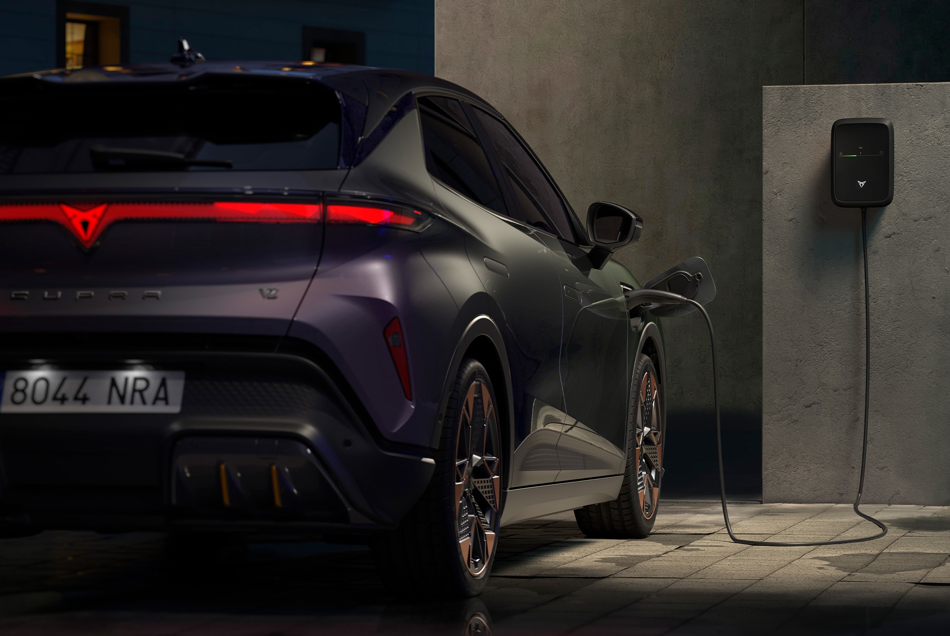 CUPRA Raval VZ rear view, charging at home.
