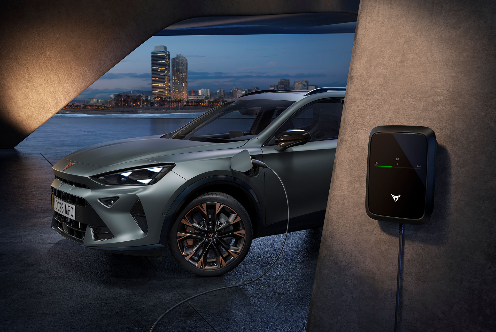 Side view of the CUPRA Formentor 2026 in the colour Enceladus Grey matt, parked in an outdoors environment showcasing the car’s charging point.  