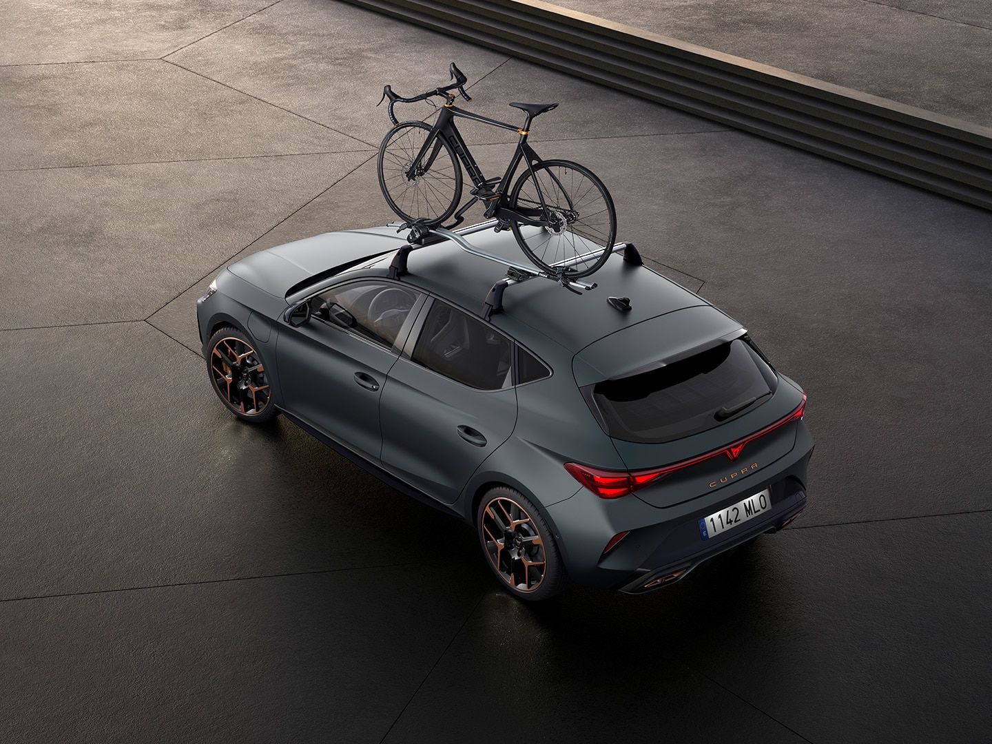 Upper side view of a CUPRA Leon featuring a bike rack from its transport accessories range.