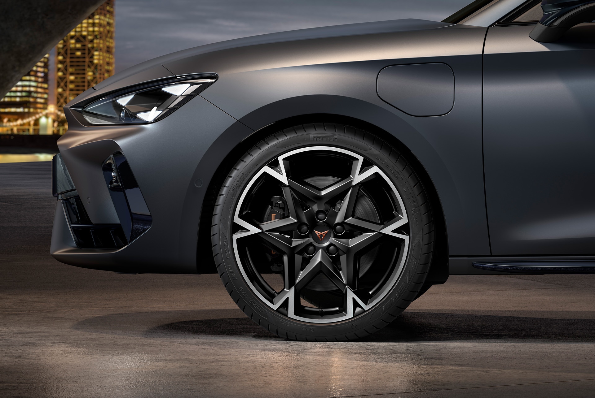 front side view of left Polar forged wheels in silver for the CUPRA Leon Estate, tyres, signature headlights and grey body