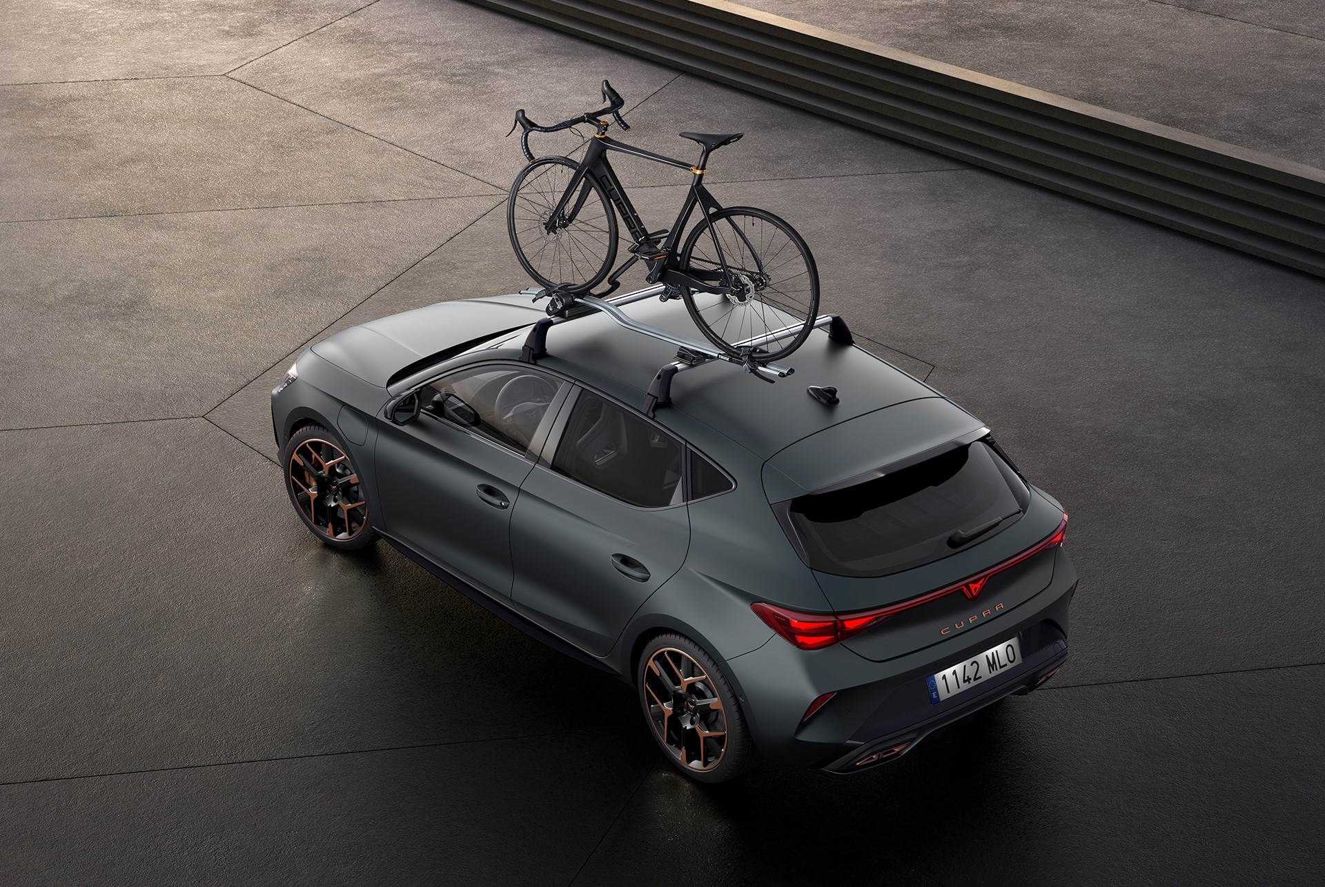 Bird’s eye view of new enceladus grey matt CUPRA Leon with car roof thule bike rack accessory
