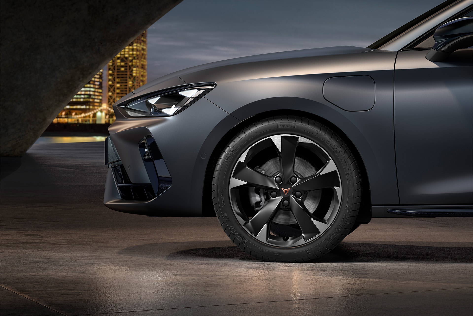 Front side view of left Garbi machined alloy wheels in silver and black for the CUPRA Leon, tyres, signature headlights and grey body
