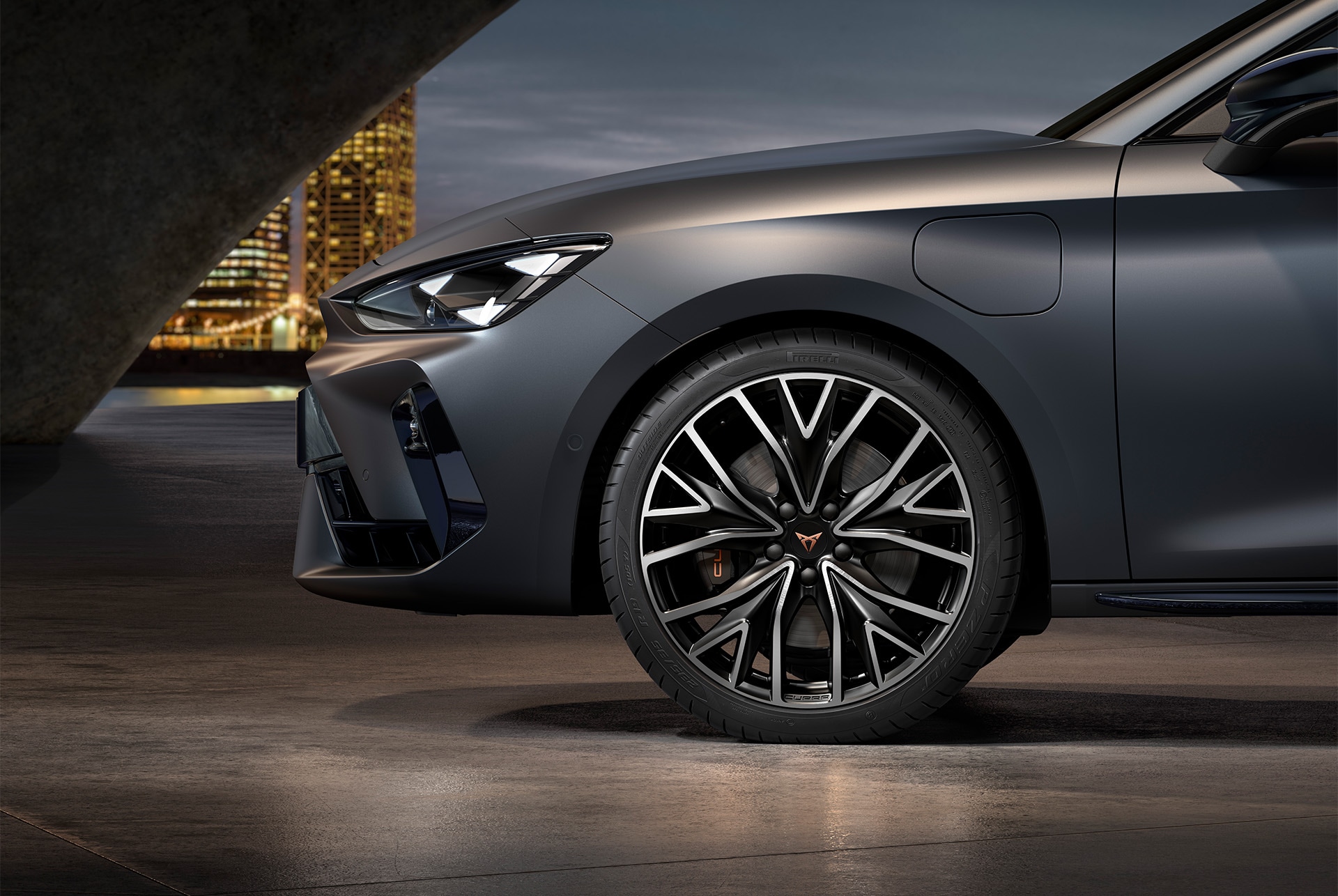 Front side view of left mistral machined alloy wheels in silver and black for the CUPRA Leon, tyres, signature headlights and grey body
