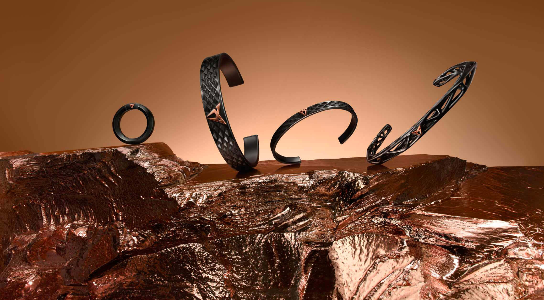 Four black textured bracelets with triangular metal accents, arranged on molten metal or rock. Four black textured bracelets with triangular metal accents, arranged on molten metal or rock.