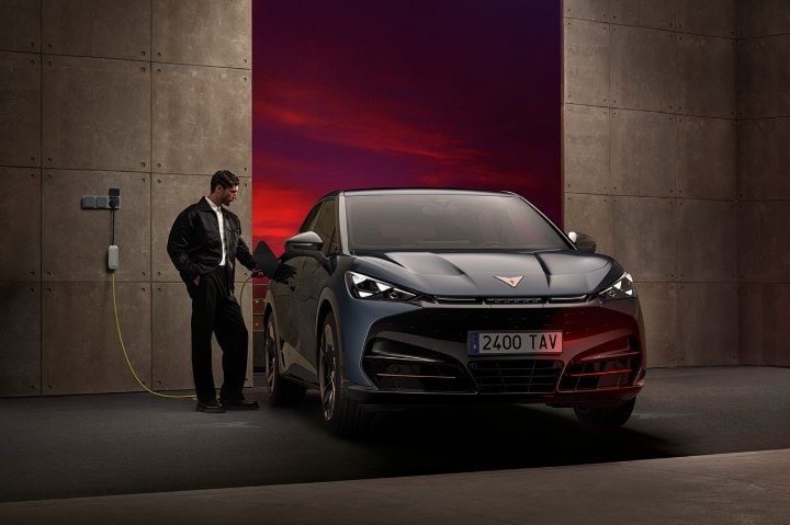 A man plugging in his CUPRA Tavascan to charge at home A man plugging in his CUPRA Tavascan to charge at home