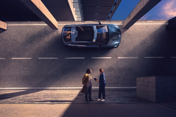 CUPRA Leon Estate being driven in a city with two men standing nearby CUPRA Leon Estate being driven in a city with two men standing nearby