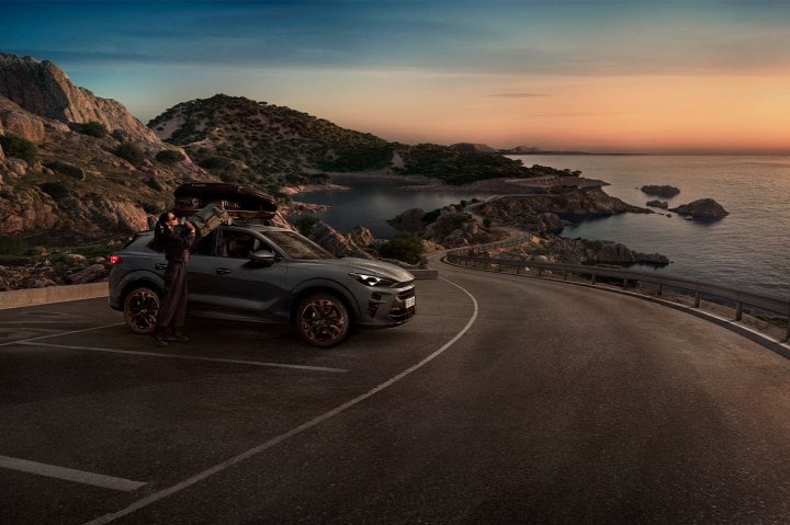 A CUPRA Terramar parked on the side of the road overlooking the sea