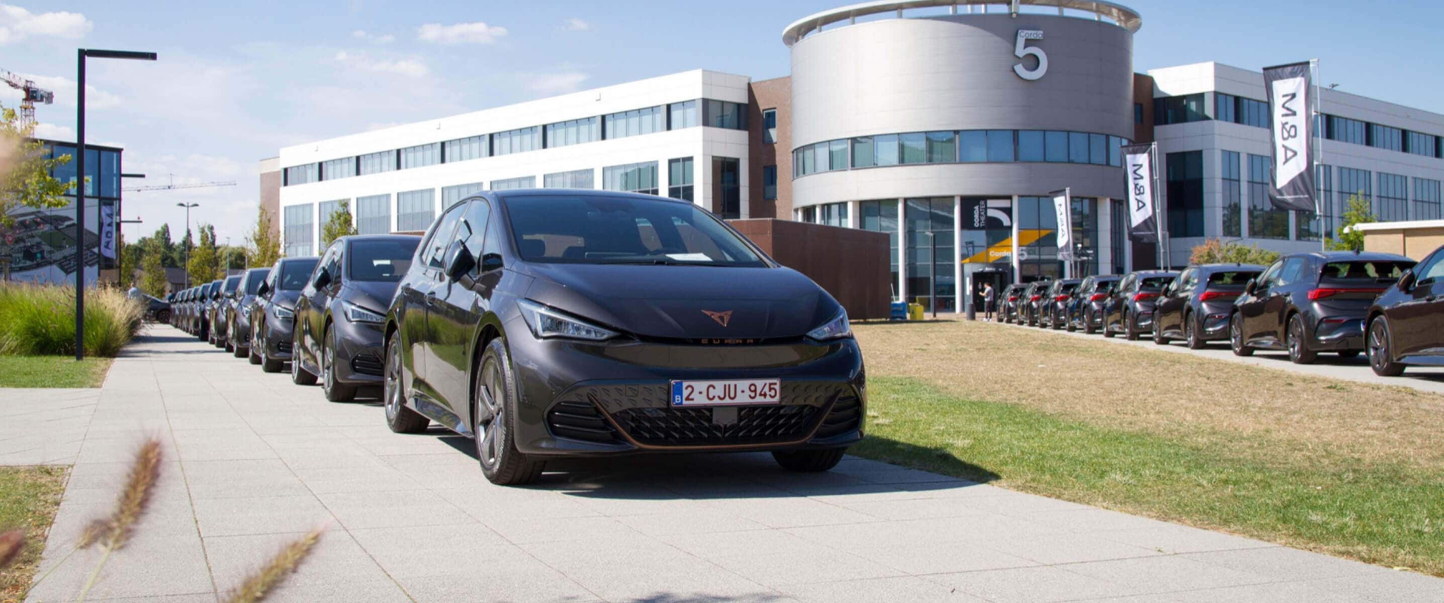 CUPRA fleet management electric vehicles from CUPRA for your business needs, building in the background.