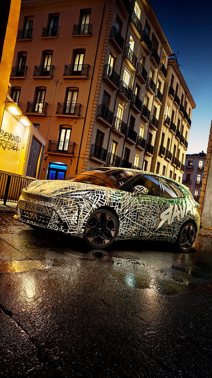 A green patterned CUPRA Raval parked on a city road