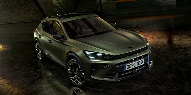 CUPRA Formentor in matte green finish parked indoors with dramatic lighting and industrial design elements. CUPRA Formentor in matte green finish parked indoors with dramatic lighting and industrial design elements.